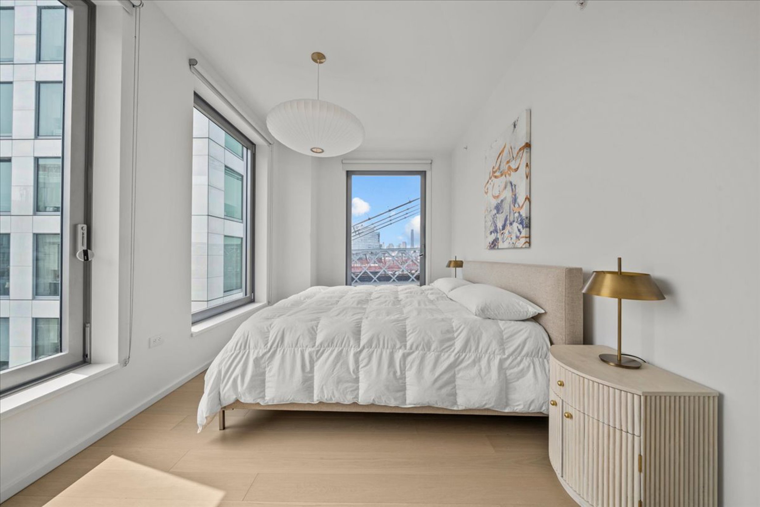 8 South 4th Street, Unit 15D Brooklyn, NY 11249 - Photo 7 of 29 a bedroom with a bed and a night stand