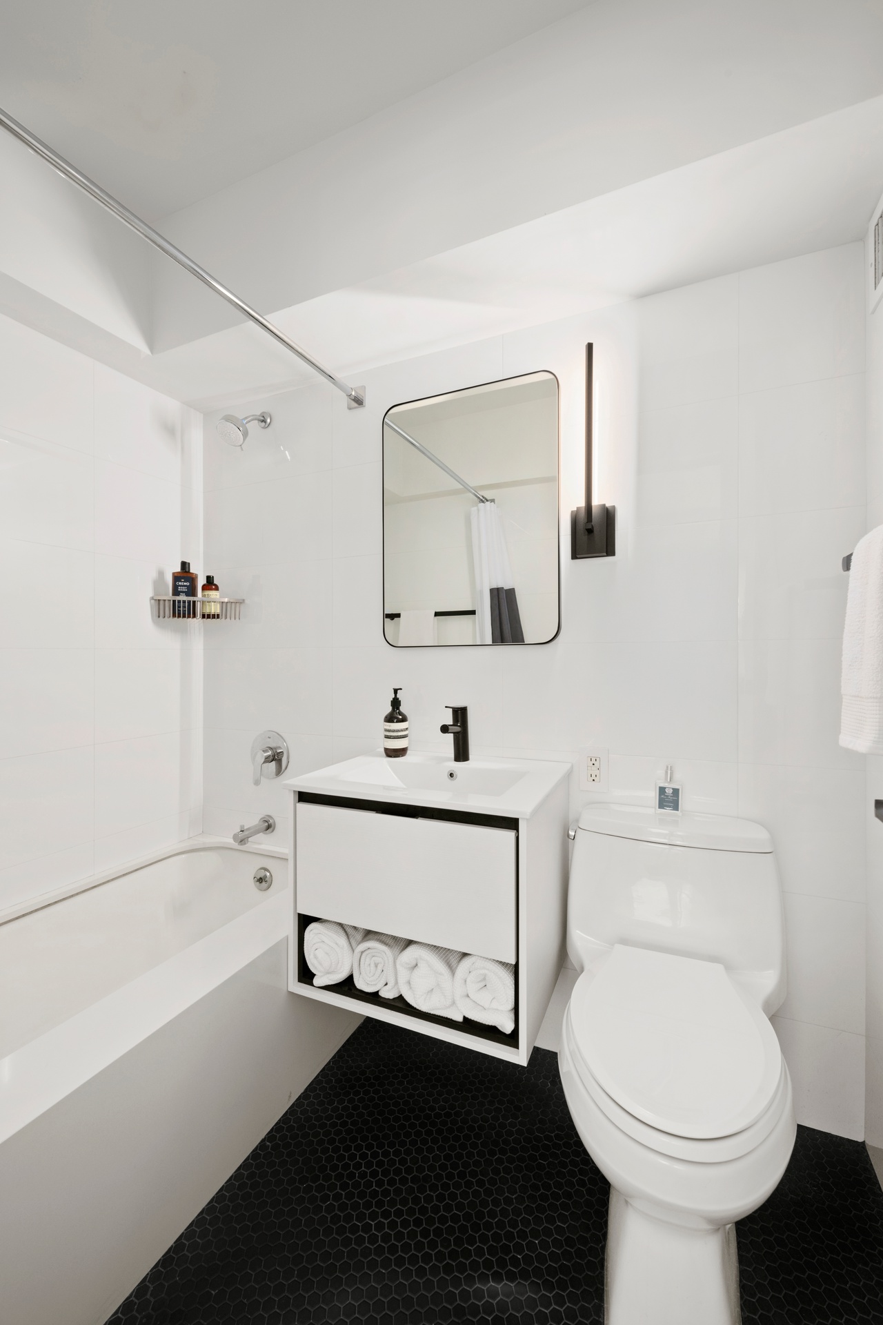 55 East 9th Street, Unit 4N Manhattan, NY 10003 - Photo 7 of 10 a bathroom with a sink a toilet and shower