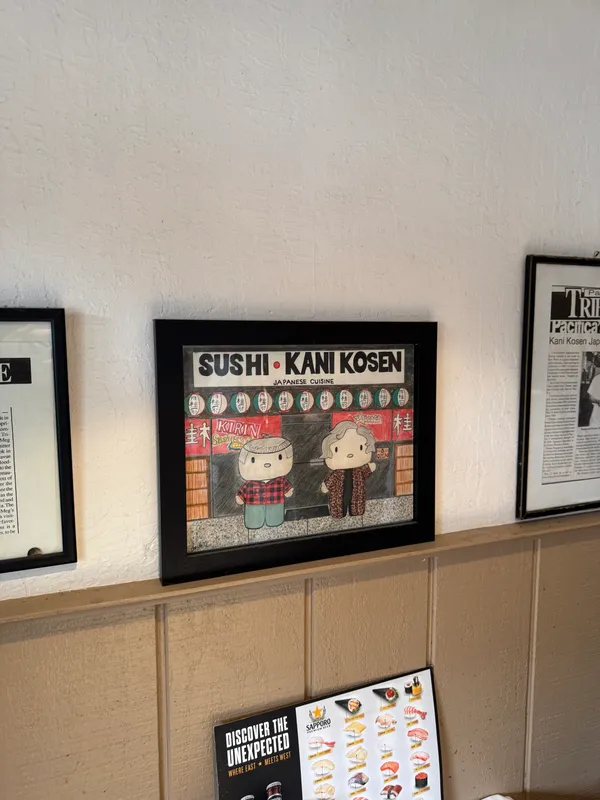 a group of people sitting on a shelf in a kitchen