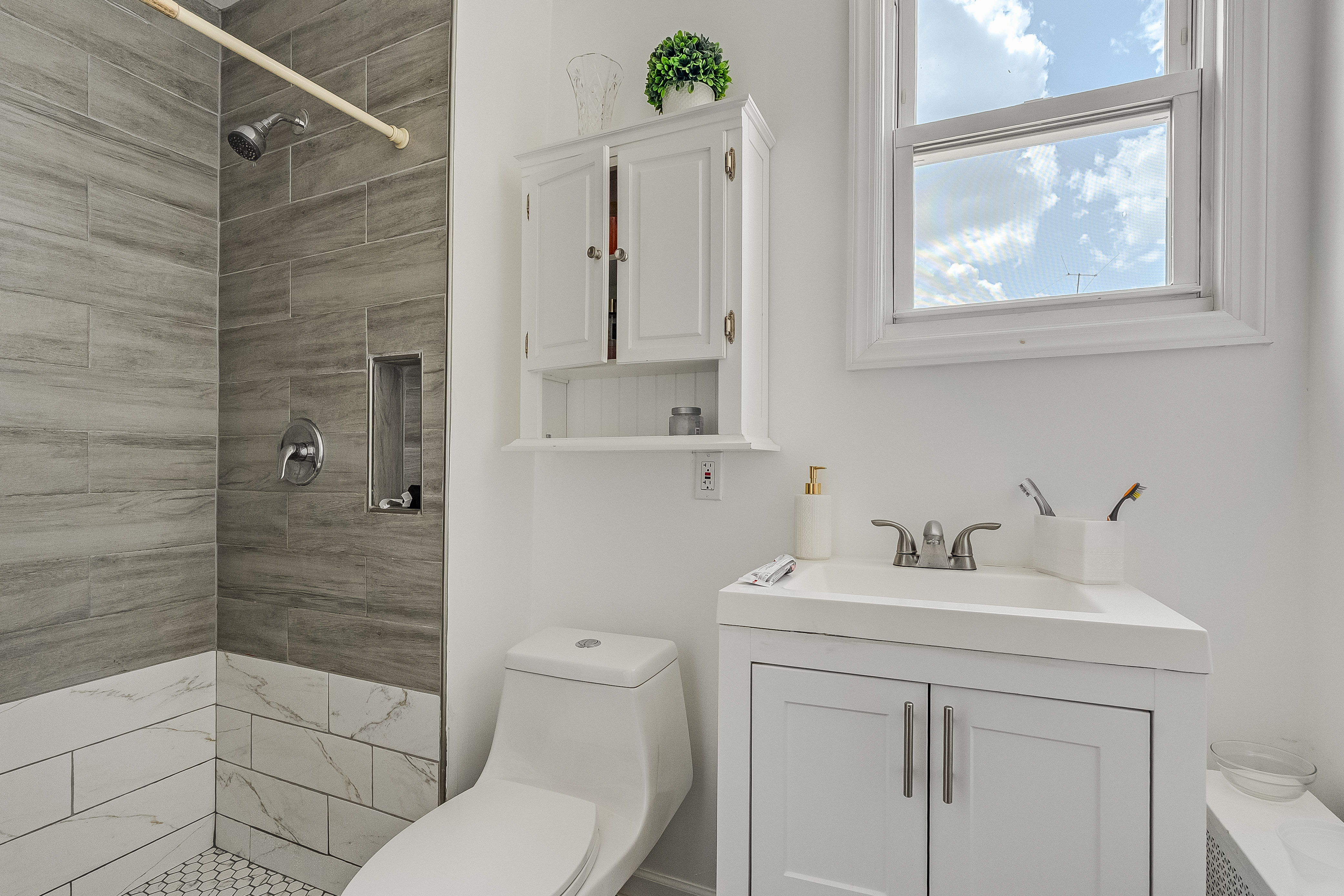 102-104 22nd Avenue Paterson, NJ 07513 - Photo 13 of 37 a bathroom with a sink toilet and shower