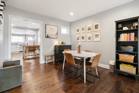 a view of a dining room with furniture and wooden floor