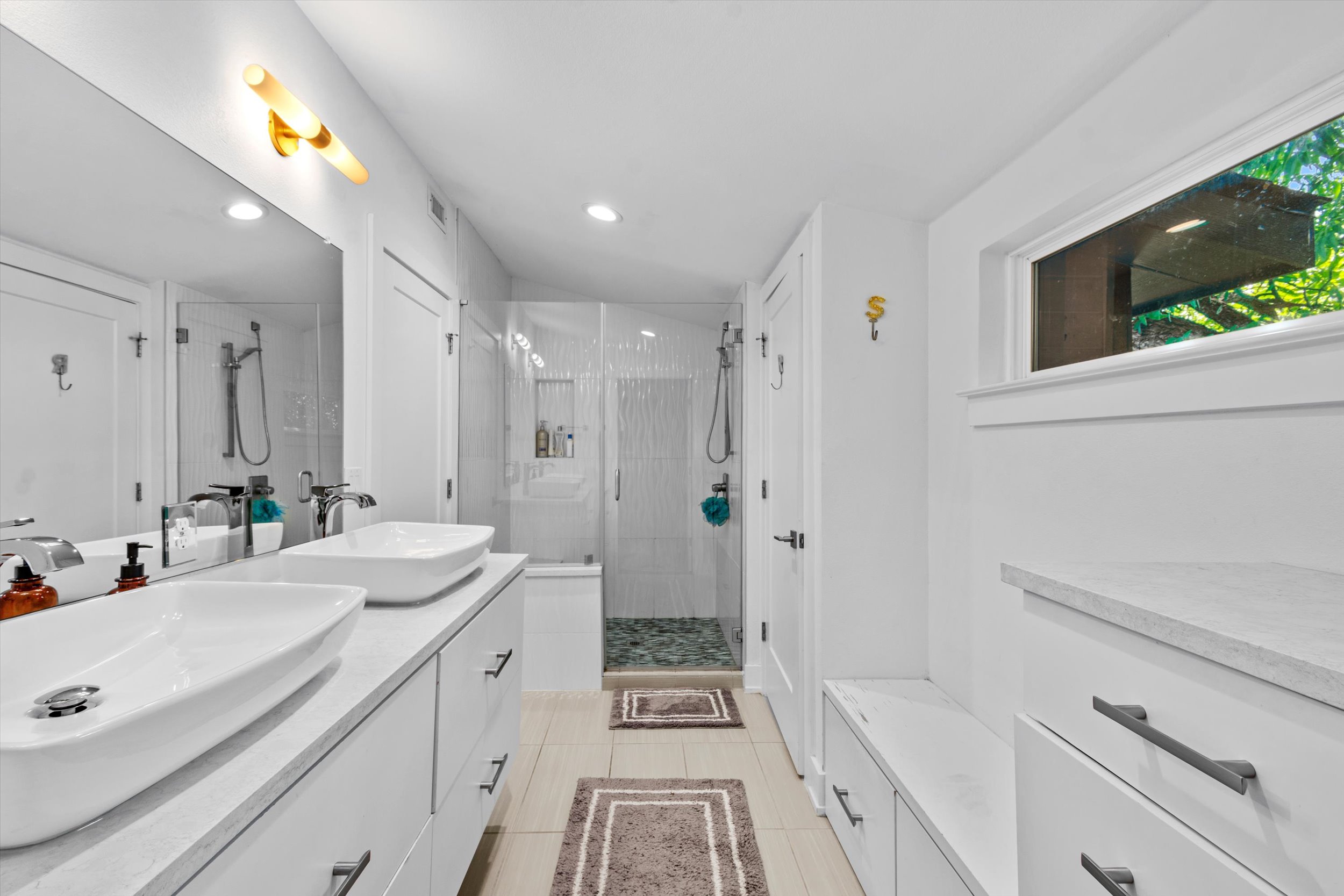2712 Oak Springs Drive, Unit A Austin, TX 78702 - Photo 10 of 38 a spacious bathroom with a double vanity sink a mirror and a shower