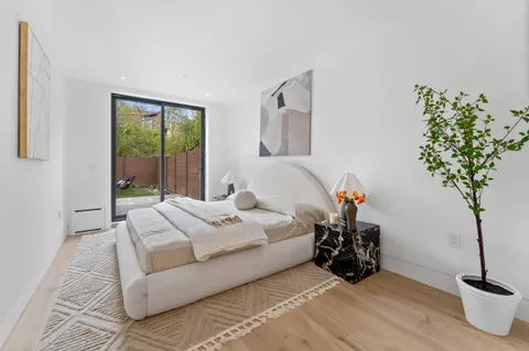 a bedroom with bed and a potted plant