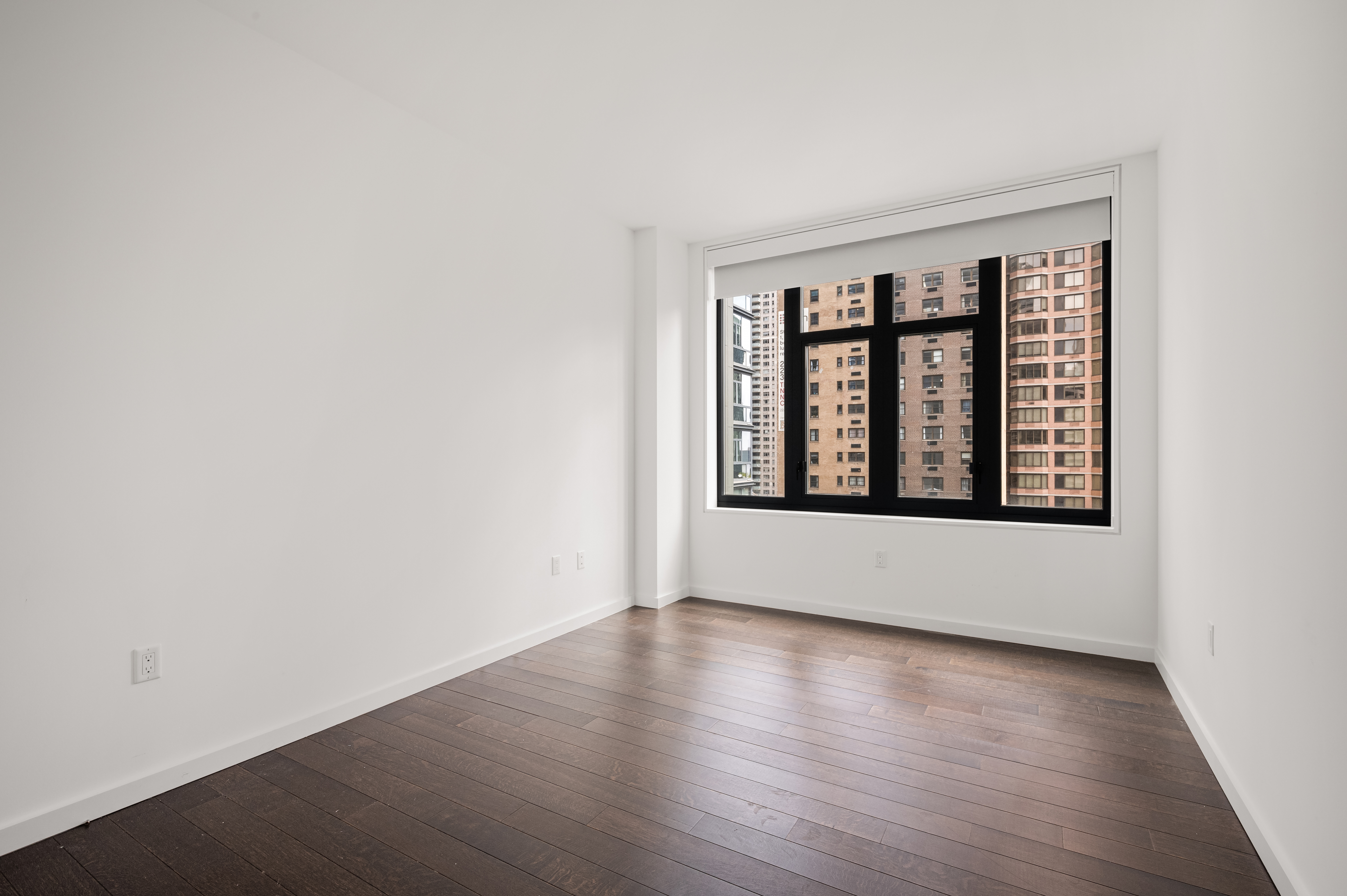 591 3rd Avenue, Unit 9C Manhattan, NY 10016 - Photo 7 of 13 an empty room with wooden floor and windows