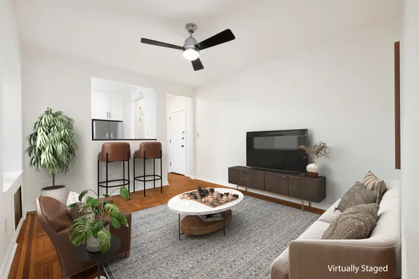 a living room with furniture and a potted plant
