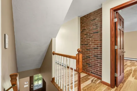 a view of staircase with railing and a window