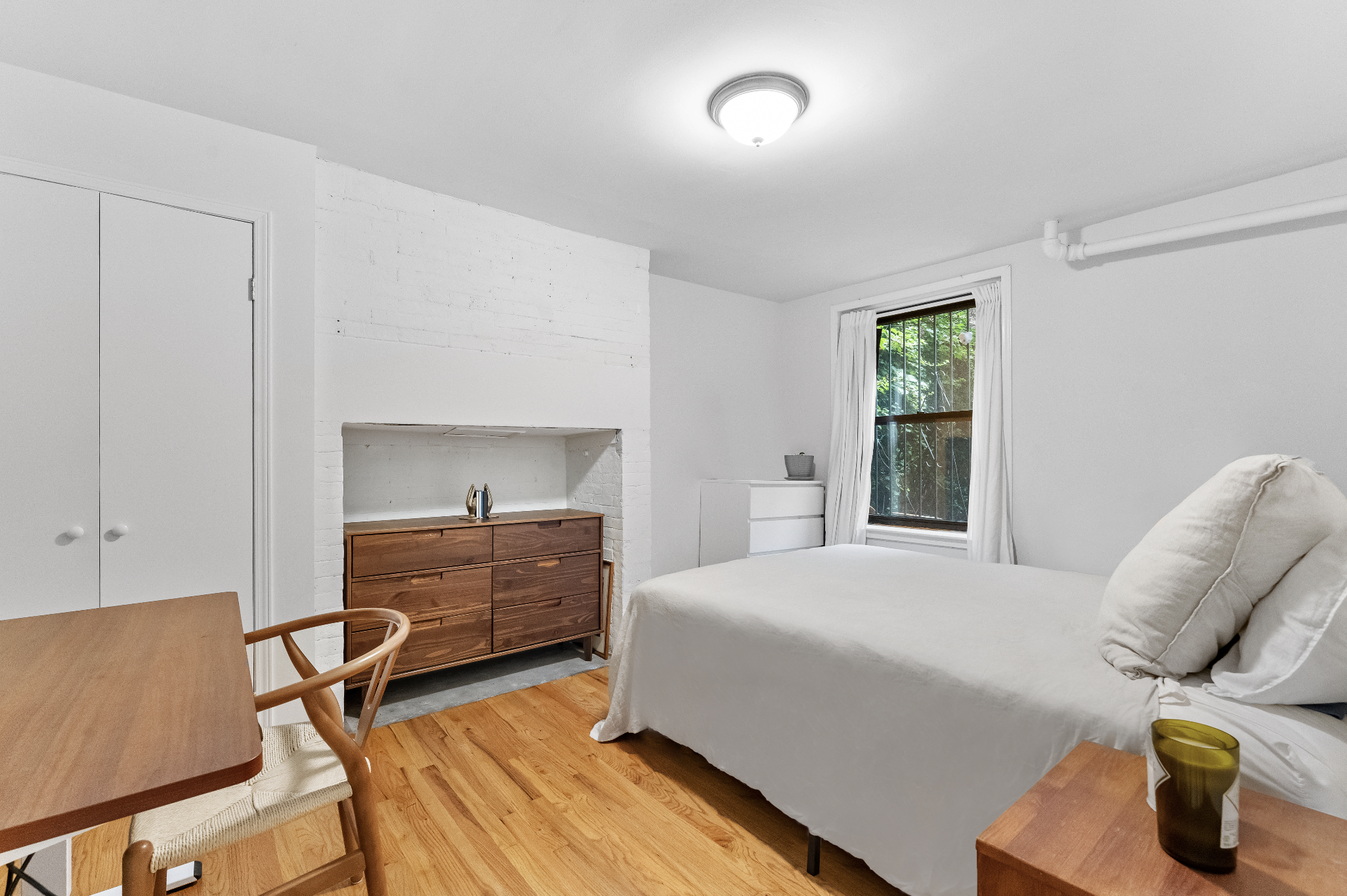 355 West 20th Street, Unit 1 Manhattan, NY 10011 - Photo 5 of 9 a bedroom with a bed and furniture