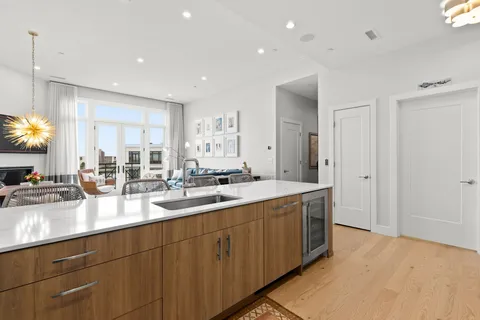 a kitchen with sink stove and cabinets