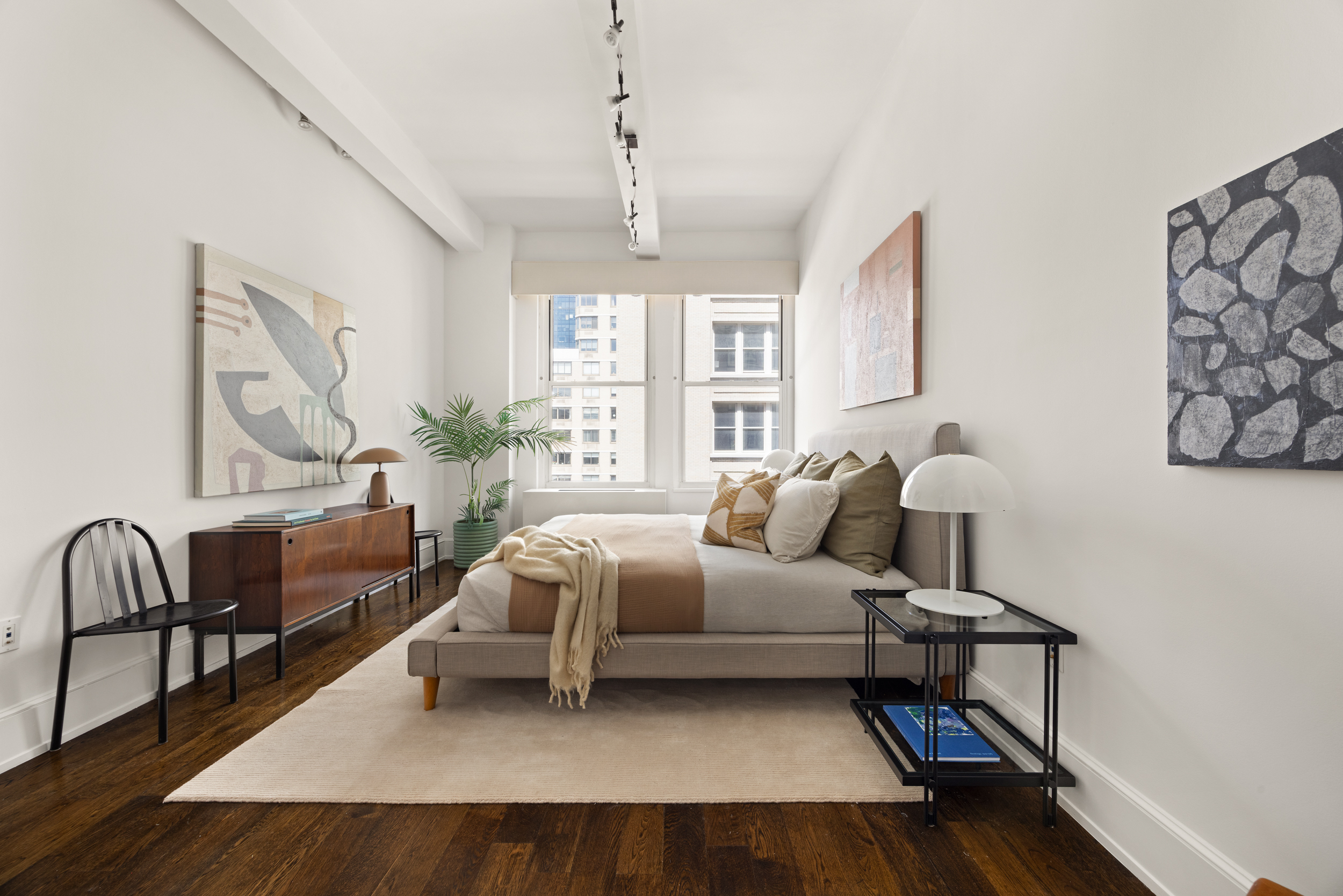 260 Park Avenue South, Unit 9G Manhattan, NY 10010 - Photo 8 of 17 a bedroom with furniture and a chandelier