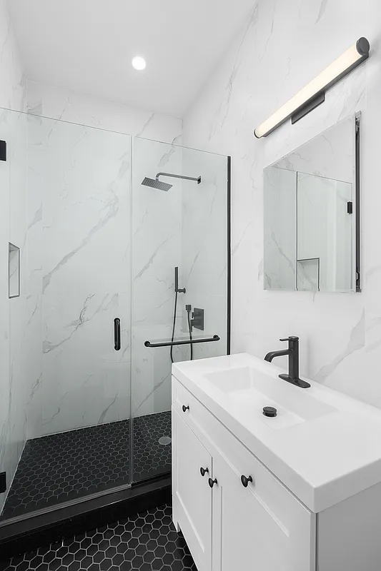 1242 Putnam Avenue, Unit 2 Brooklyn, NY 11221 - Photo 5 of 8 a bathroom with a sink a toilet and shower