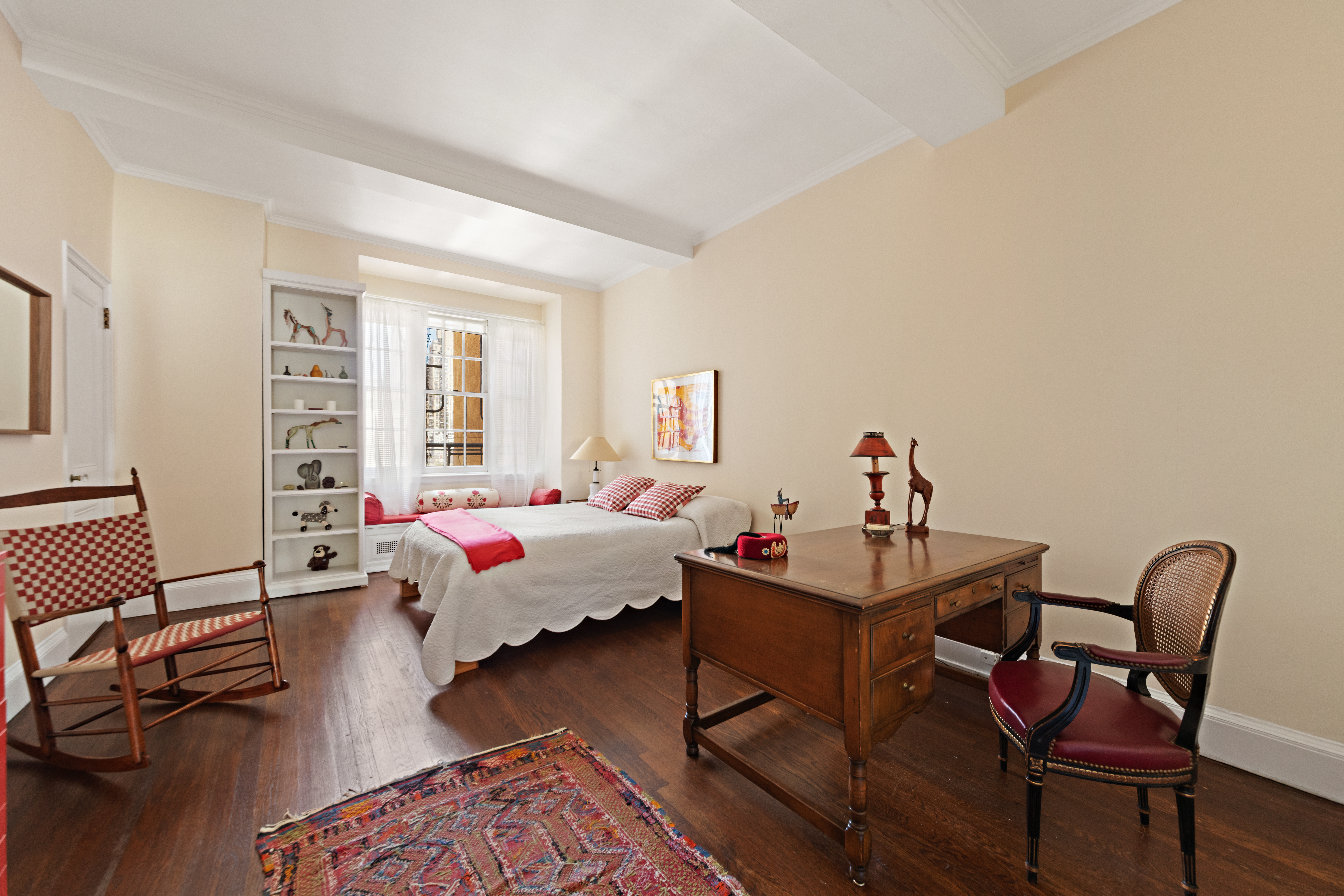 151 East 79th Street Manhattan, NY 10075 - Photo 11 of 15 a bedroom with a bed and wooden floor