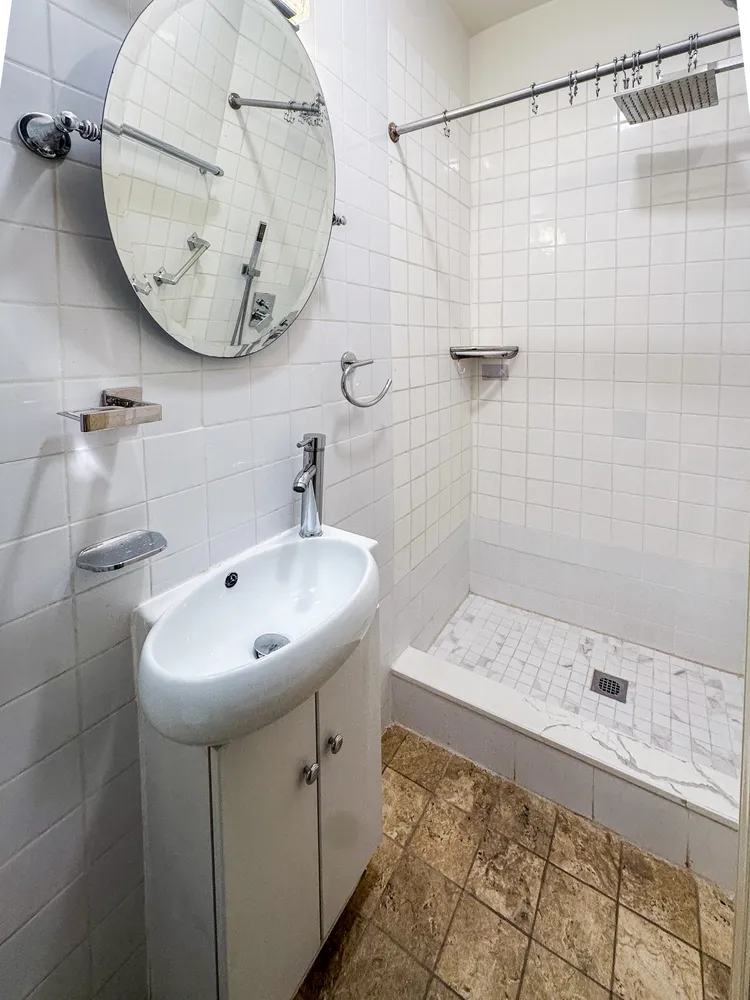 a bathroom with a sink a toilet and shower