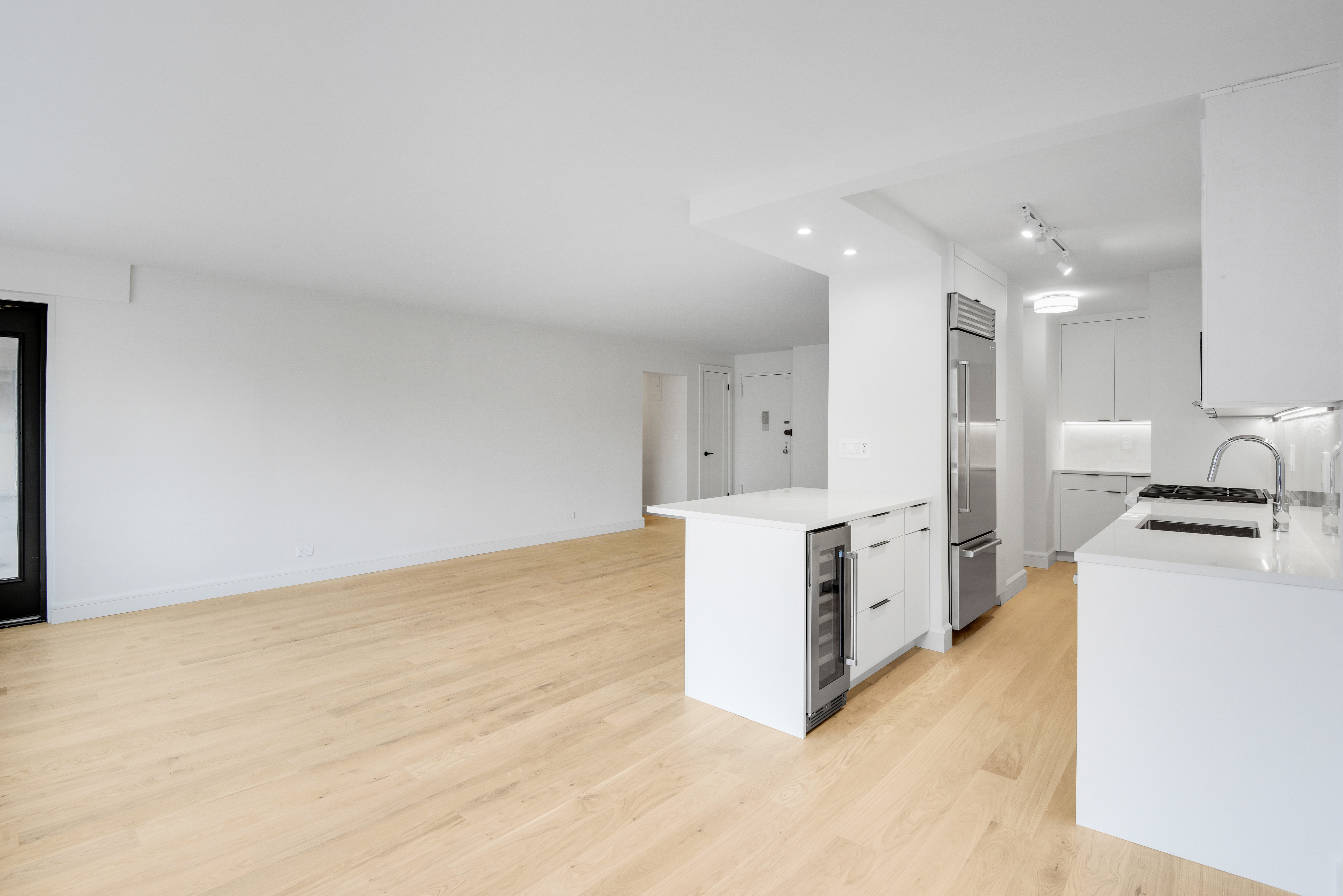 205 West End Avenue, Unit 15H Manhattan, NY 10023 - Photo 5 of 17 a large kitchen with stainless steel appliances a large counter top a stove and a refrigerator