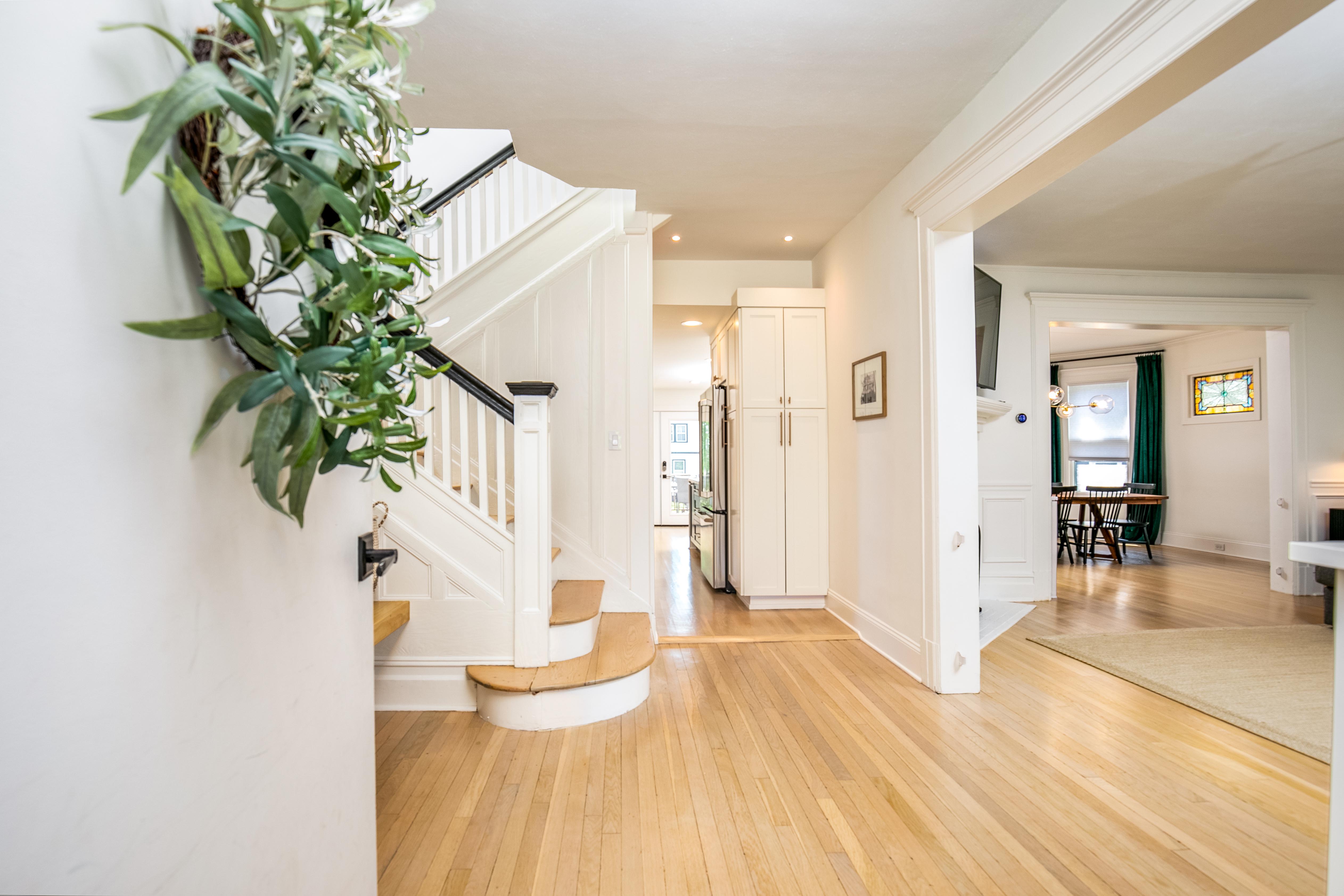 163 Ridge Road Rutherford, NJ 07070 - Photo 7 of 59 a view of a hallway with wooden floor and a potted plant