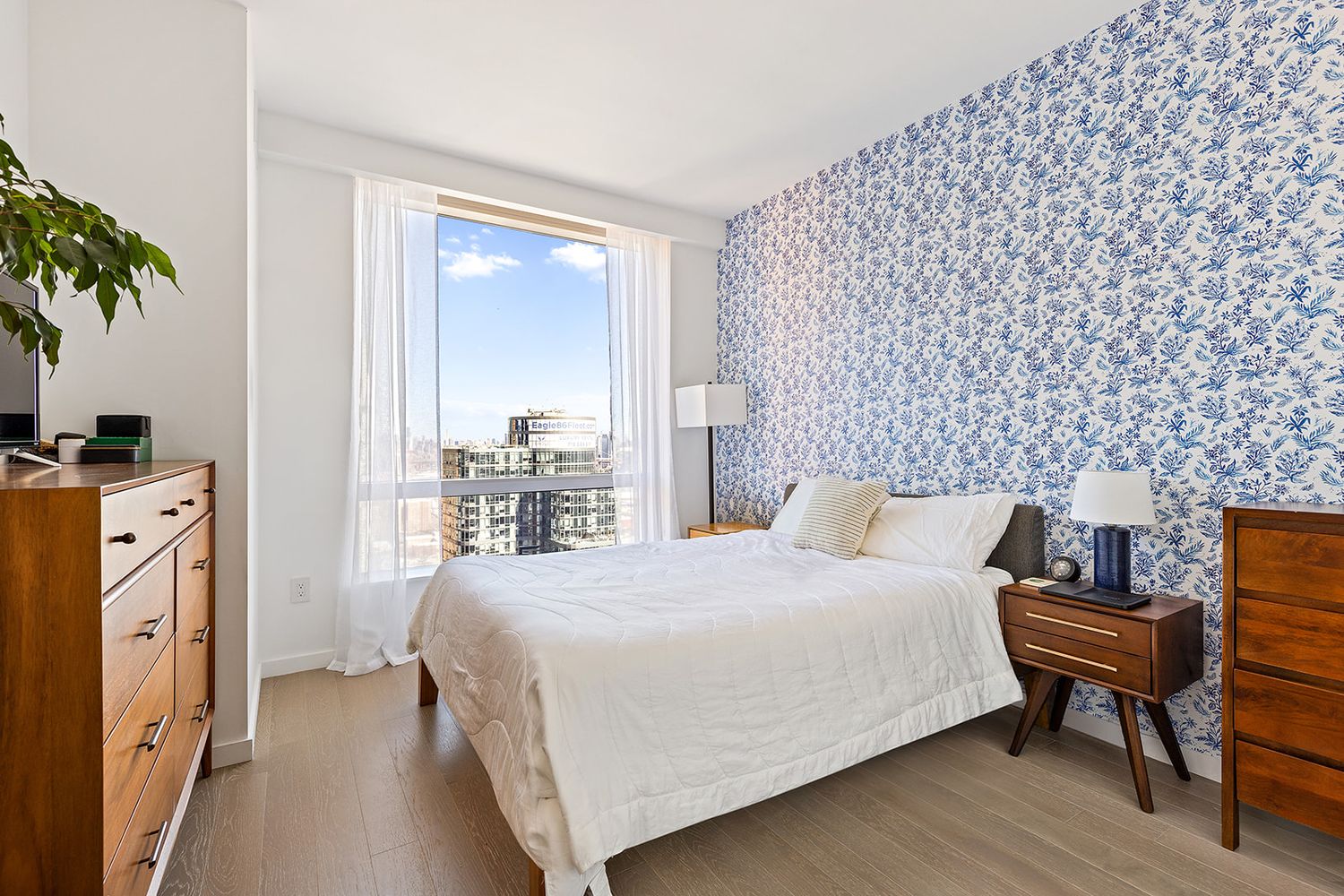 1 City Point, Unit 36D Brooklyn, NY 11201 - Photo 3 of 16 a bedroom with a bed and a potted plant next to a window