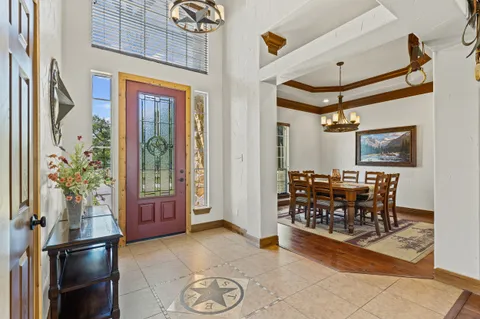 a view of a dining room with furniture wooden floor and chandelier