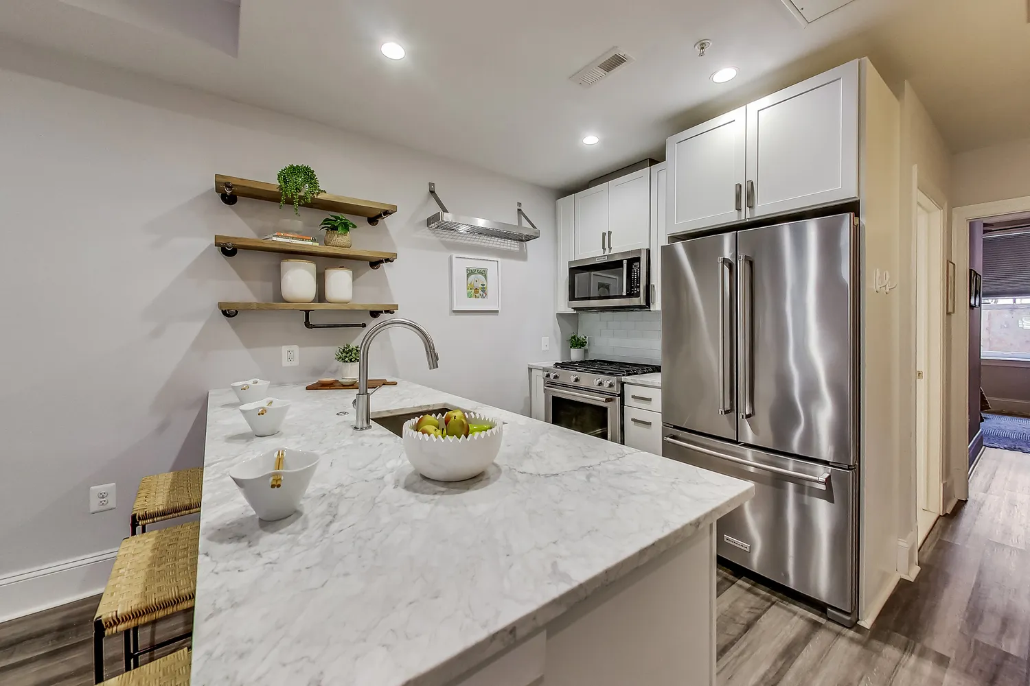 a kitchen with stainless steel appliances a refrigerator a sink and a stove