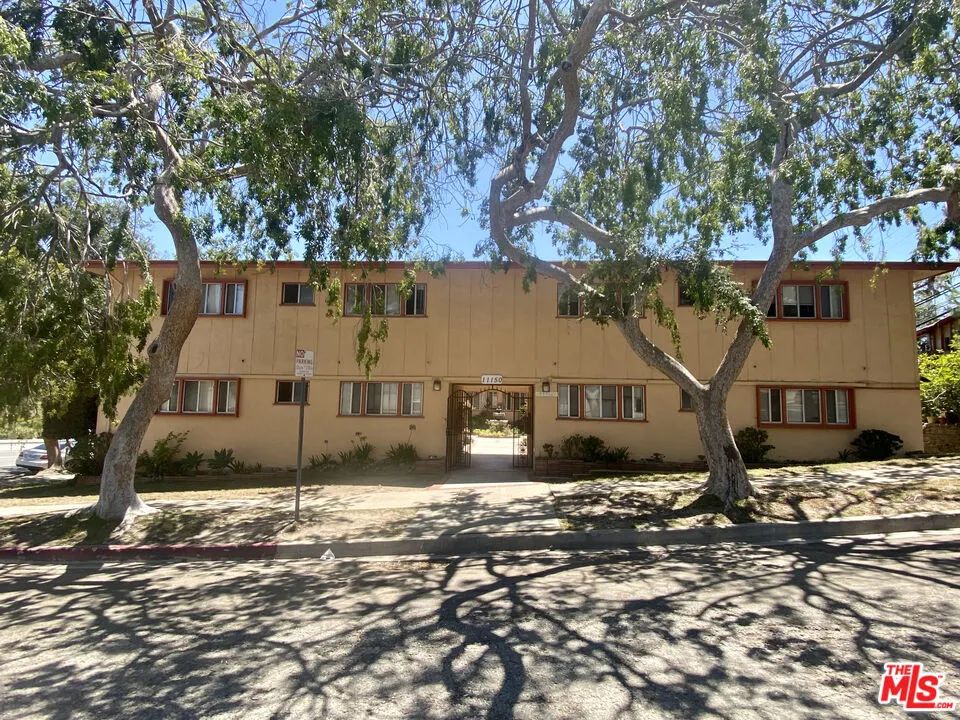 front view of a house with a large tree