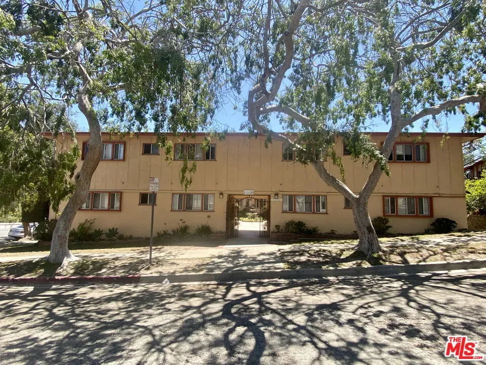 front view of a house with a large tree