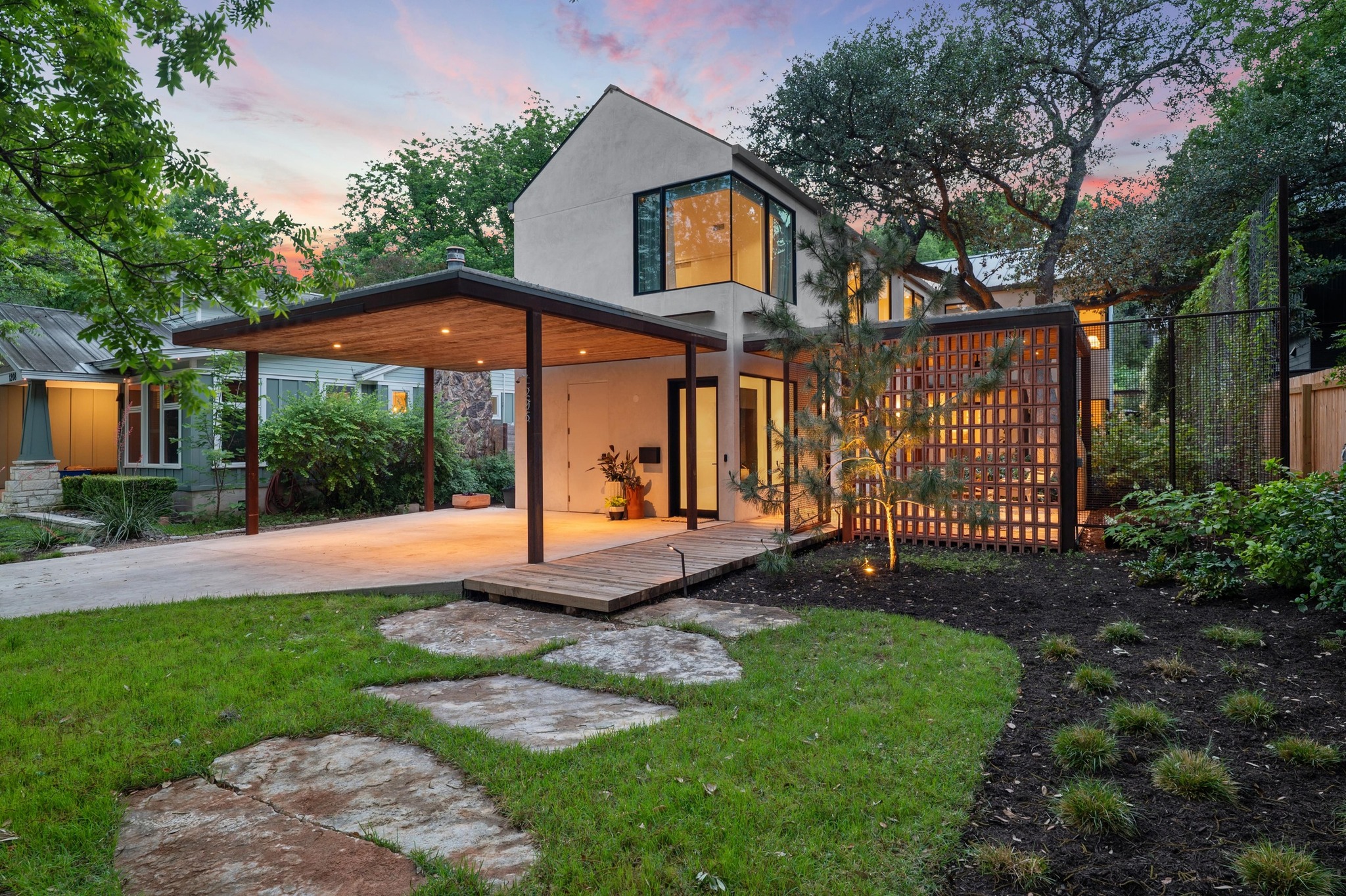1206 Bickler Road Austin, TX 78704 - Photo 3 of 65 a view of a white house next to a yard with big trees