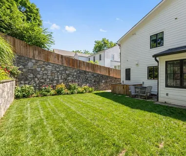 a view of a backyard with plants and a garden