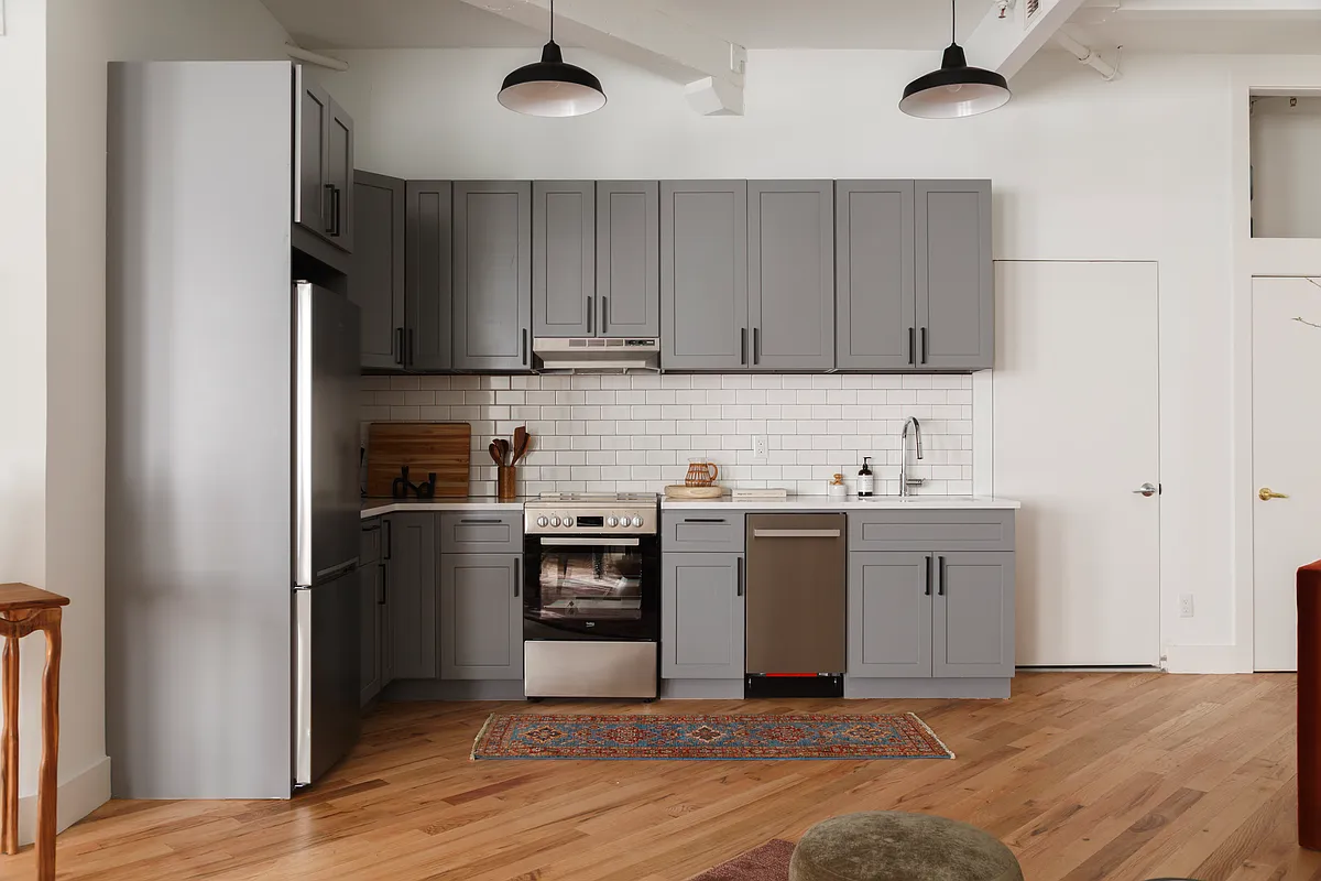239 Banker Street, Unit 4K Brooklyn, NY 11222 - Photo 9 of 13 a kitchen with stainless steel appliances granite countertop a refrigerator and a sink