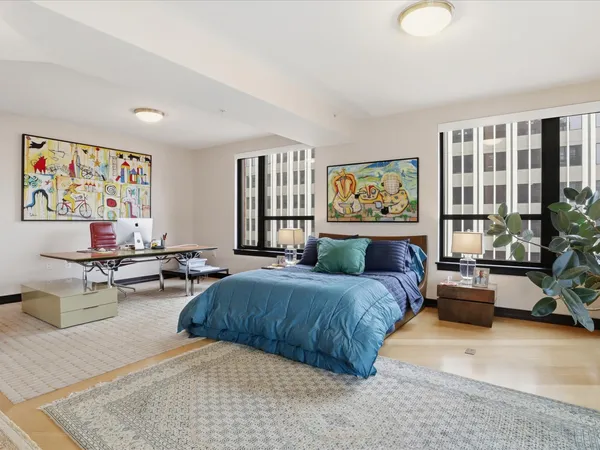 a bedroom with a bed couch and a window