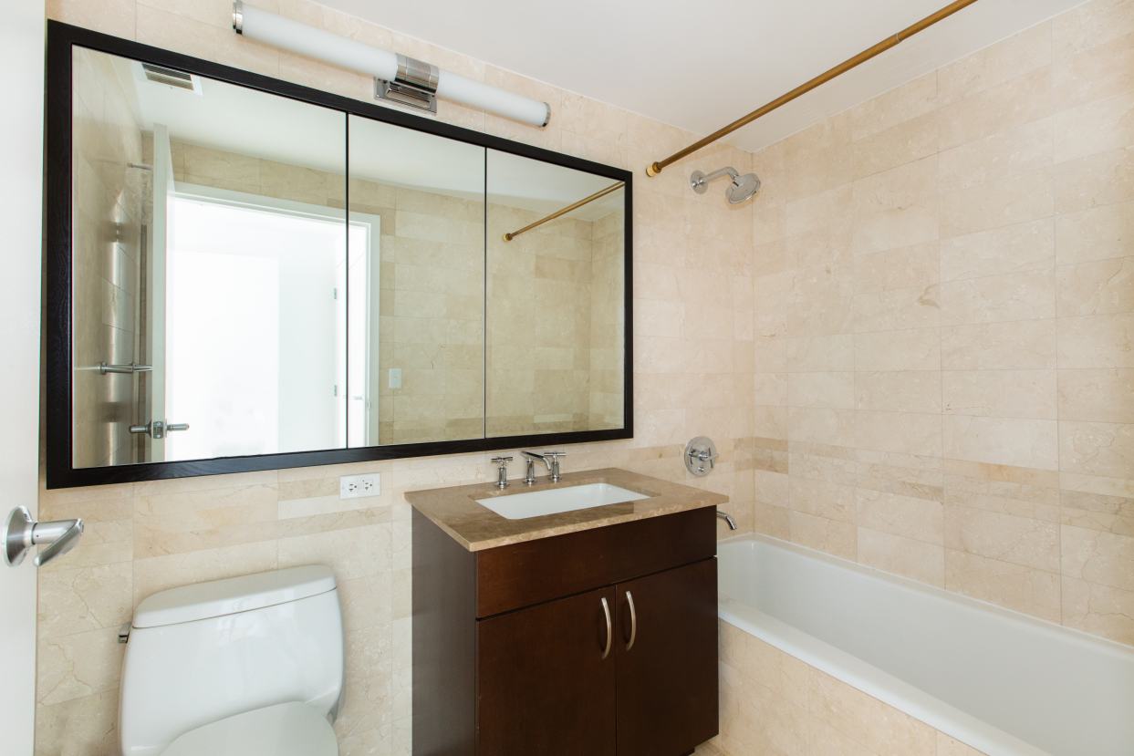 40 West 116th Street, Unit A406 Manhattan, NY 10026 - Photo 7 of 14 a bathroom with a sink and a mirror