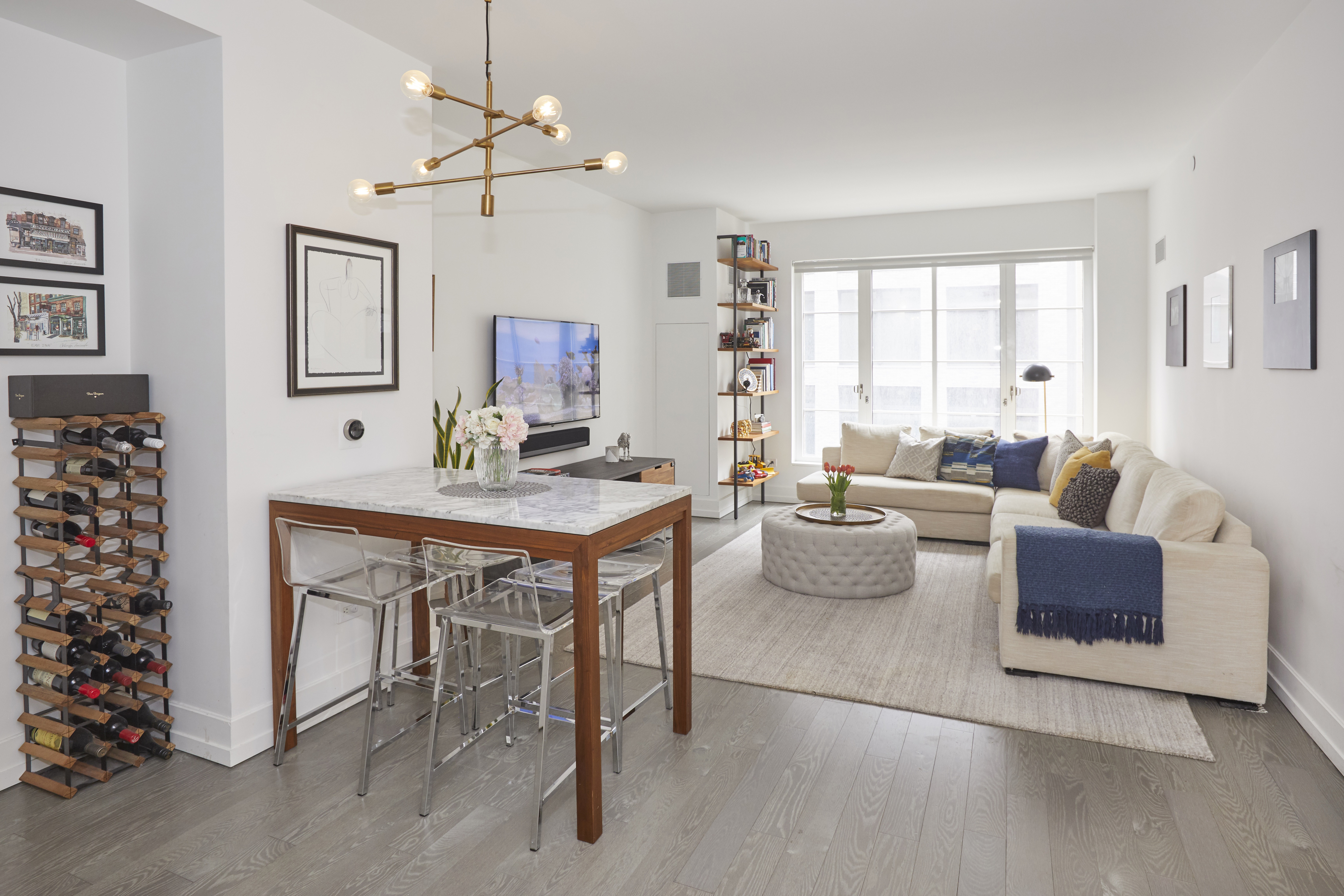 70 Charlton Street, Unit 7E Manhattan, NY 10014 - Photo 2 of 17 a work room with furniture and a chandelier