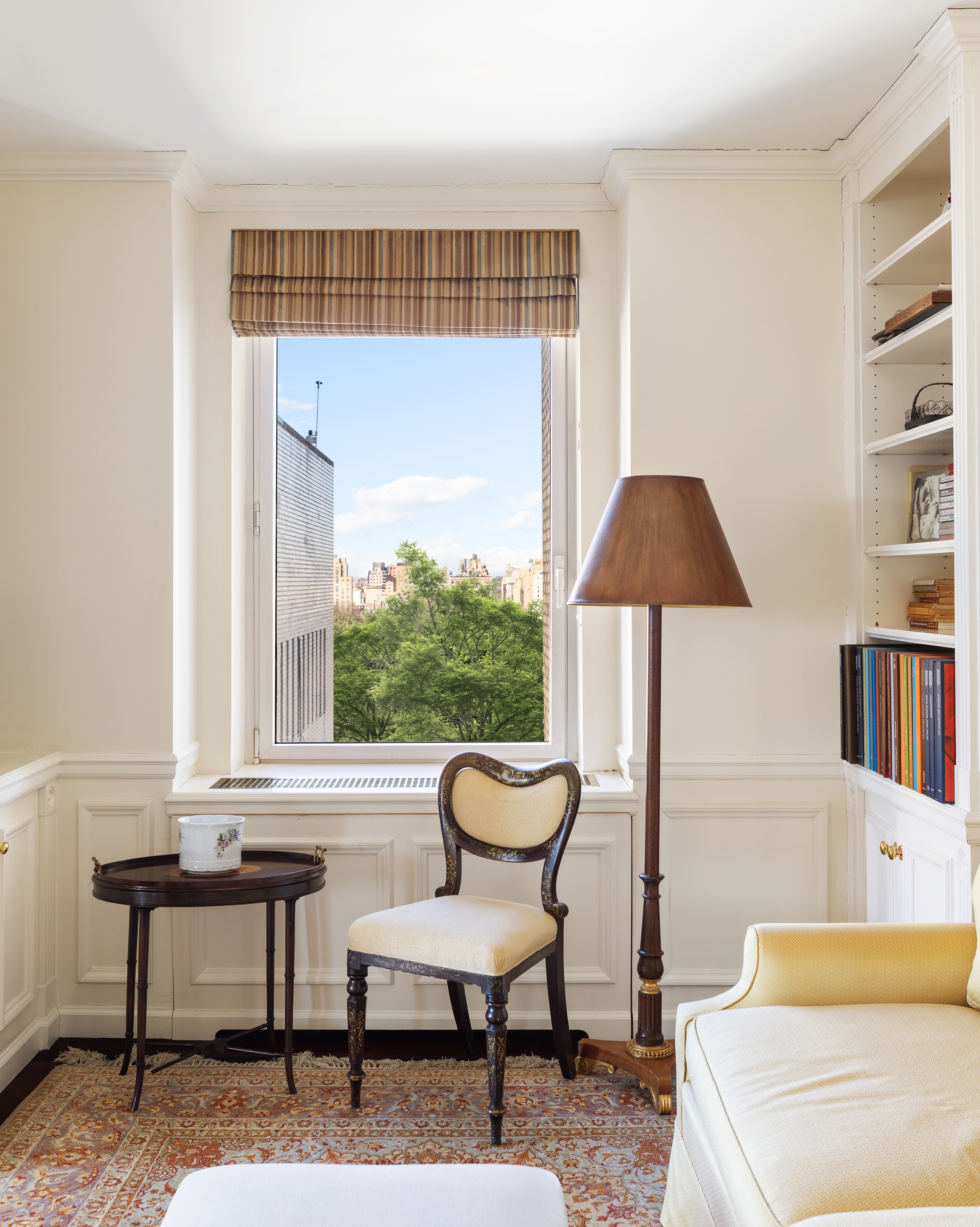 1049 5th Avenue, Unit 17A Manhattan, NY 10028 - Photo 4 of 11 a living room with furniture and a window