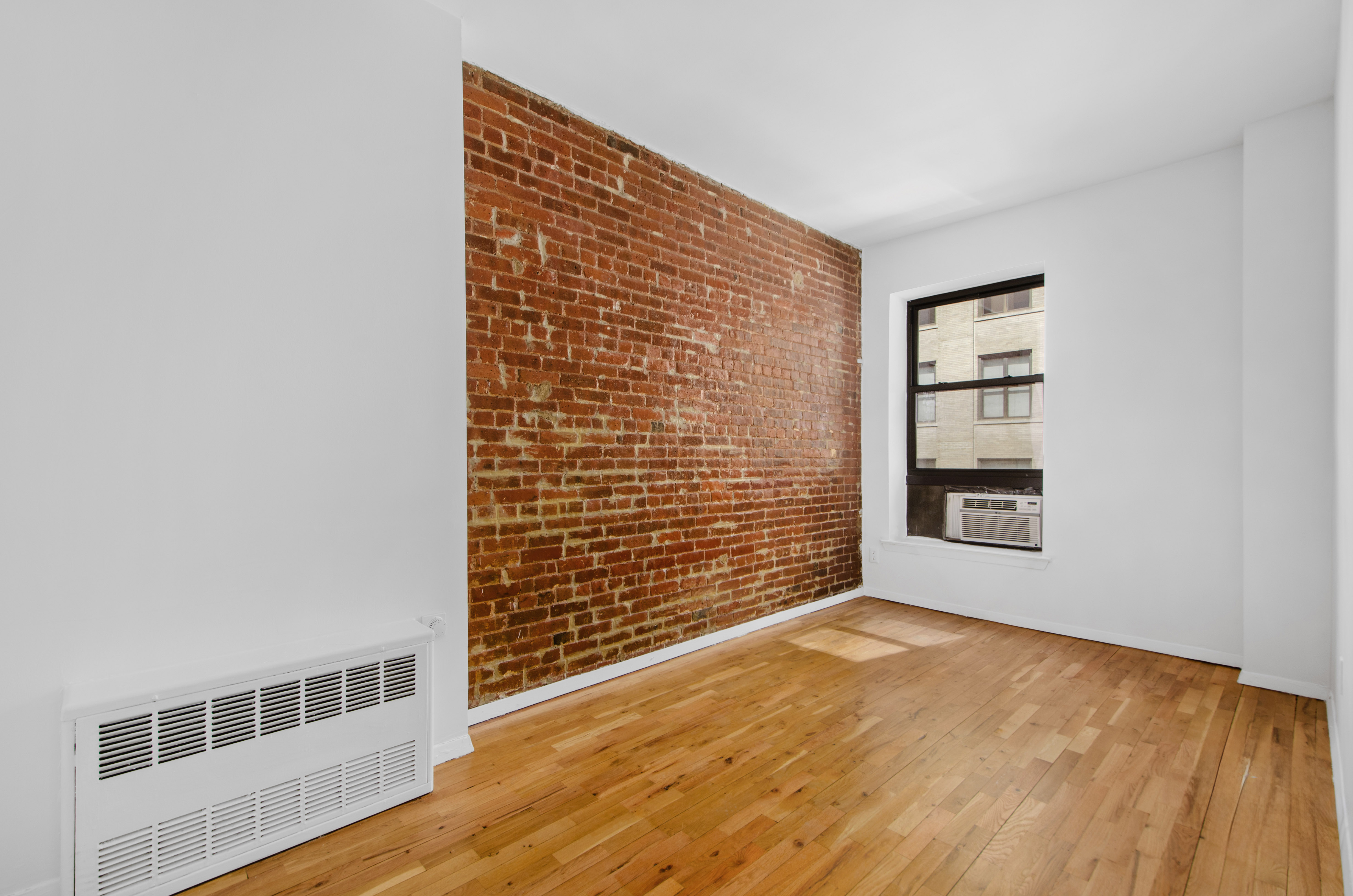 23 East 10th Street, Unit 5A Manhattan, NY 10003 - Photo 6 of 9 a view of an empty room with a window