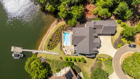 an aerial view of a house with swimming pool and outdoor space