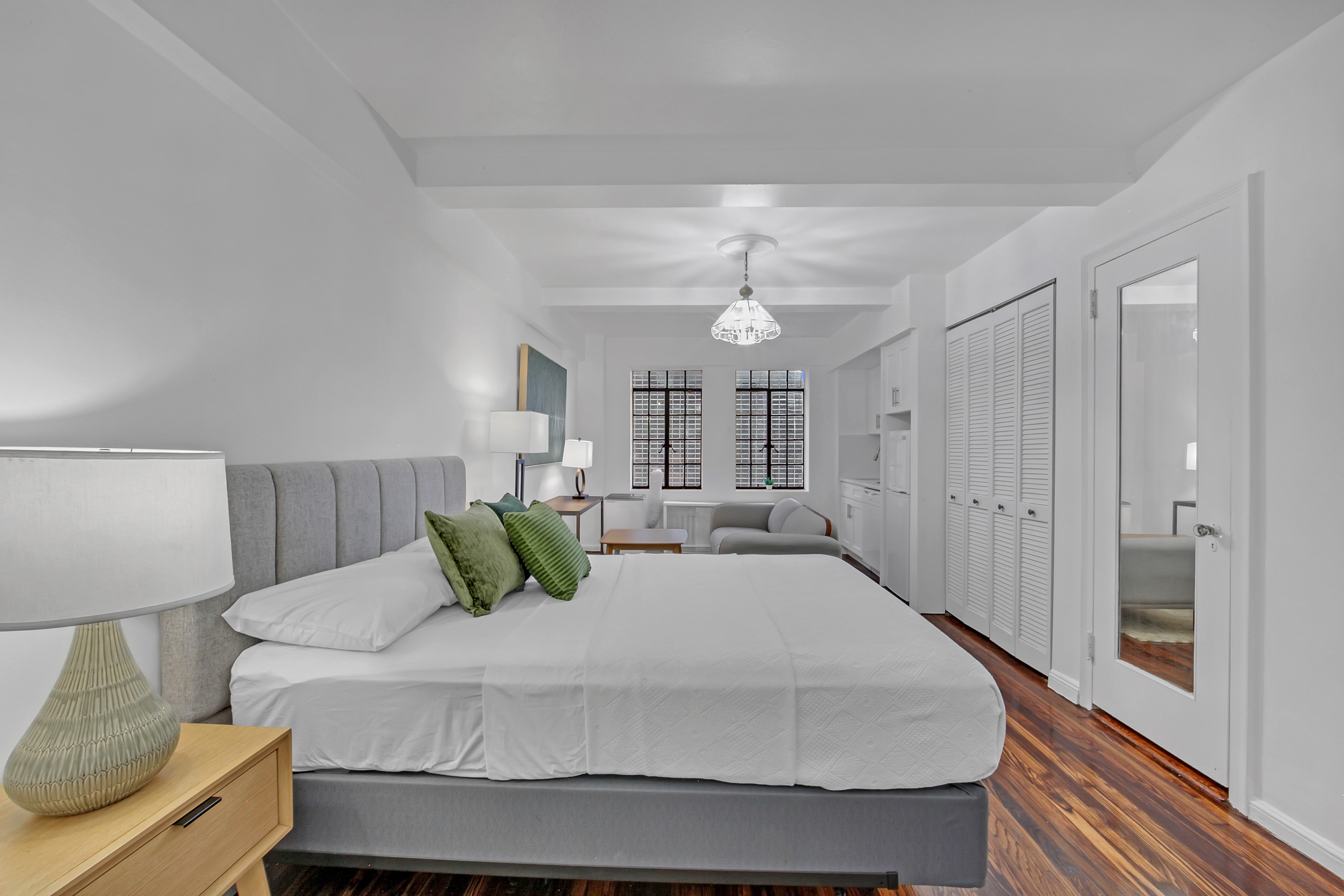 45 Tudor City Place, Unit 1902 Manhattan, NY 10017 - Photo 1 of 19 a large white bed in a white room