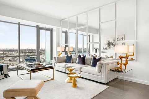 a living room with furniture a rug and white walls