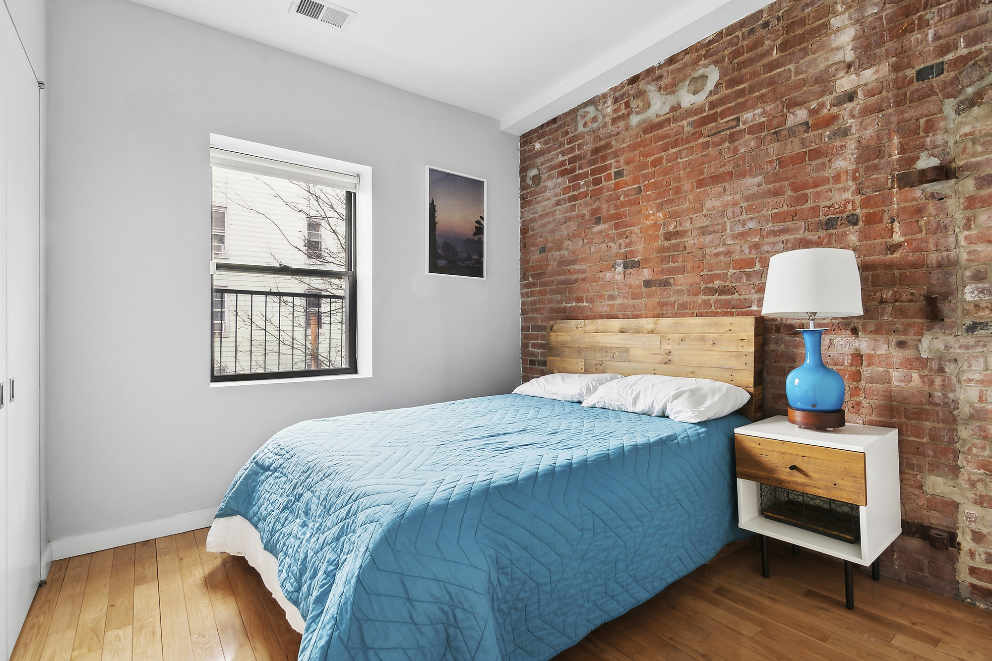 364 Manhattan Avenue, Unit 4G Brooklyn, NY 11211 - Photo 8 of 13 a bedroom with a bed and wooden floor