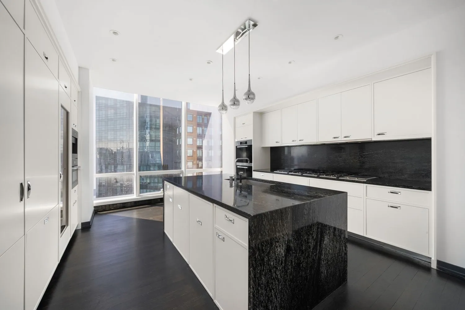 a spacious bedroom with a bed and glass window