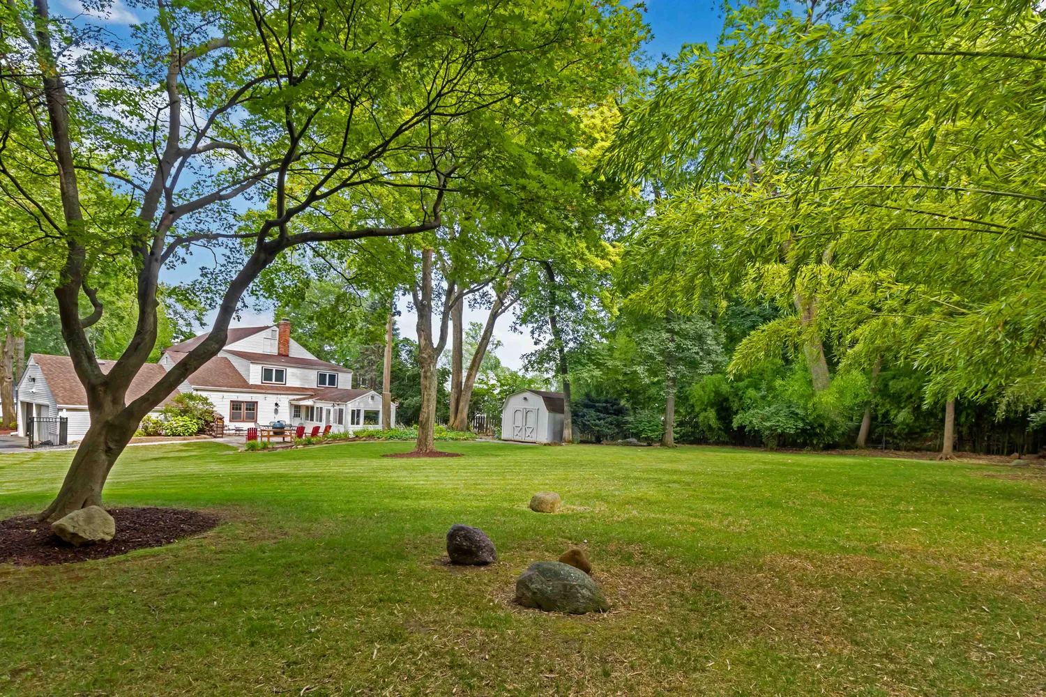 a backyard of a house with lots of green space