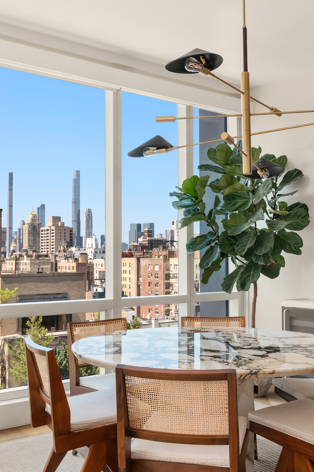151 East 85th Street, Unit 17B Manhattan, NY 10028 - Photo 5 of 10 a table with a potted plant and a table