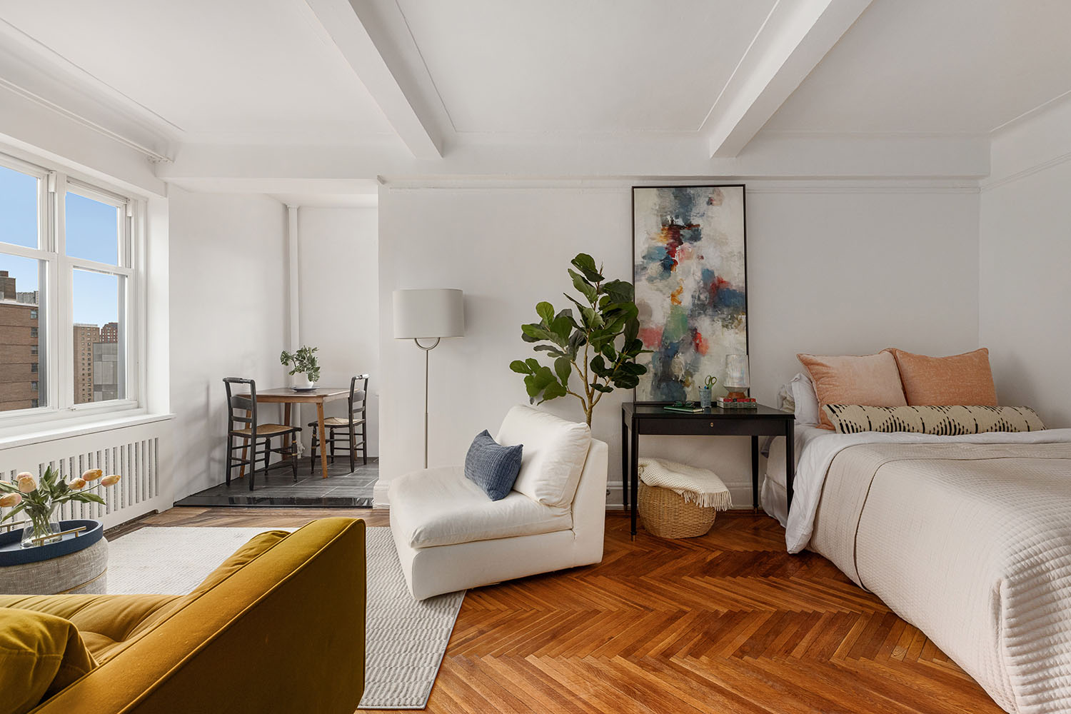 233 West 99th Street, Unit 19A Manhattan, NY 10025 - Photo 2 of 10 a bedroom with a bed and a couch