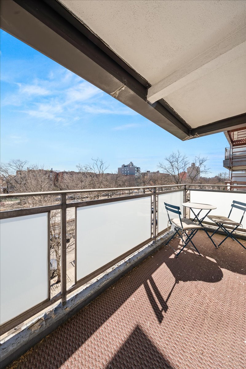 350 Ocean Parkway, Unit 3C Brooklyn, NY 11218 - Photo 9 of 10 a view of a balcony with chairs and wooden floor