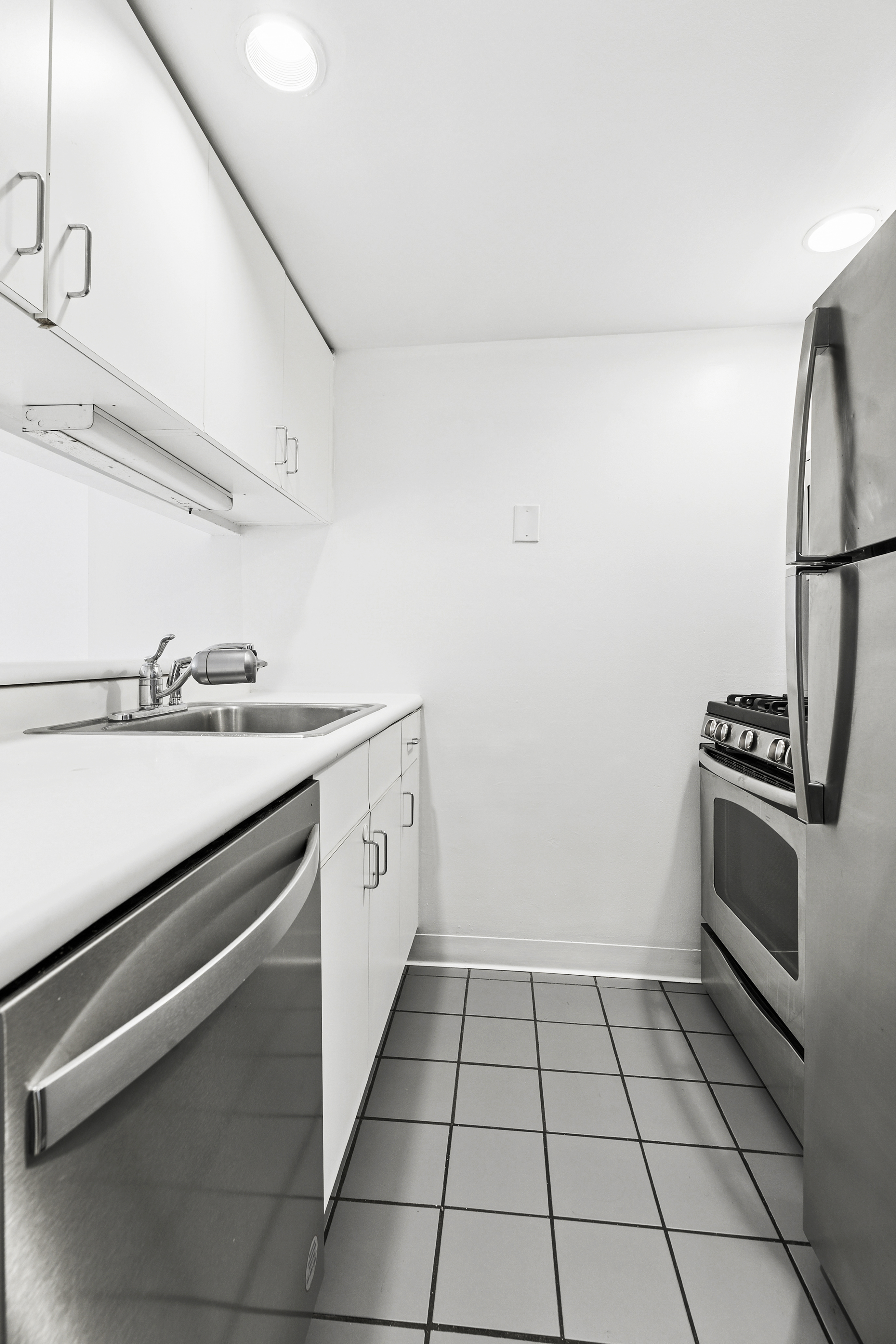 2250 Broadway, Unit 6K Manhattan, NY 10024 - Photo 8 of 15 a kitchen with a stove cabinets and a sink