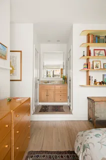 a bedroom with a bed and cabinets