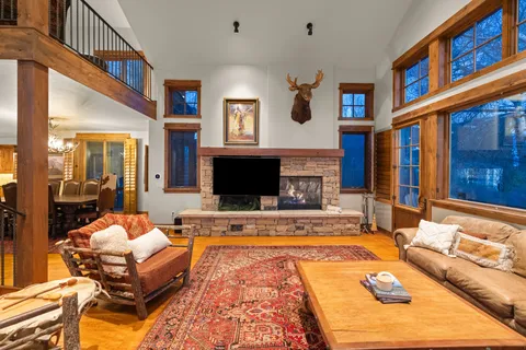 a living room with furniture rug and a fireplace