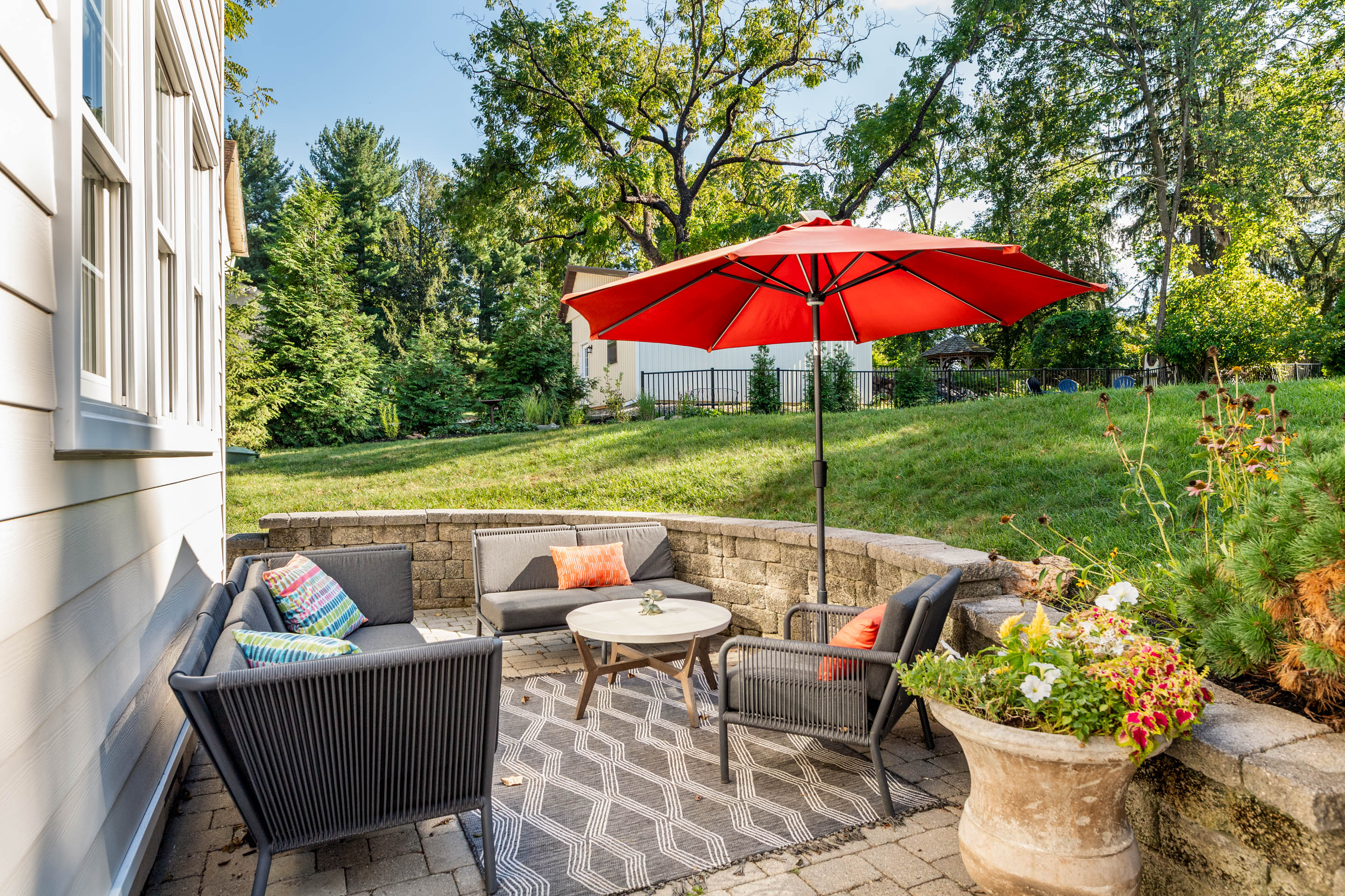 1136 Seaton Ross Road Wayne, PA 19087 - Photo 38 of 48 an outdoor sitting area with furniture and umbrella