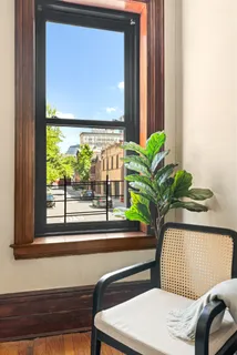 a potted plant sitting on a window sill and a wooden door