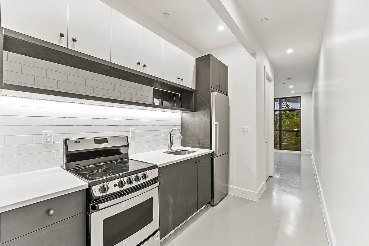 30 Belvidere Street, Unit 1B Brooklyn, NY 11206 - Photo 3 of 6 a kitchen with a stove and a refrigerator