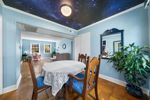 a view of a dining room with furniture and wooden floor