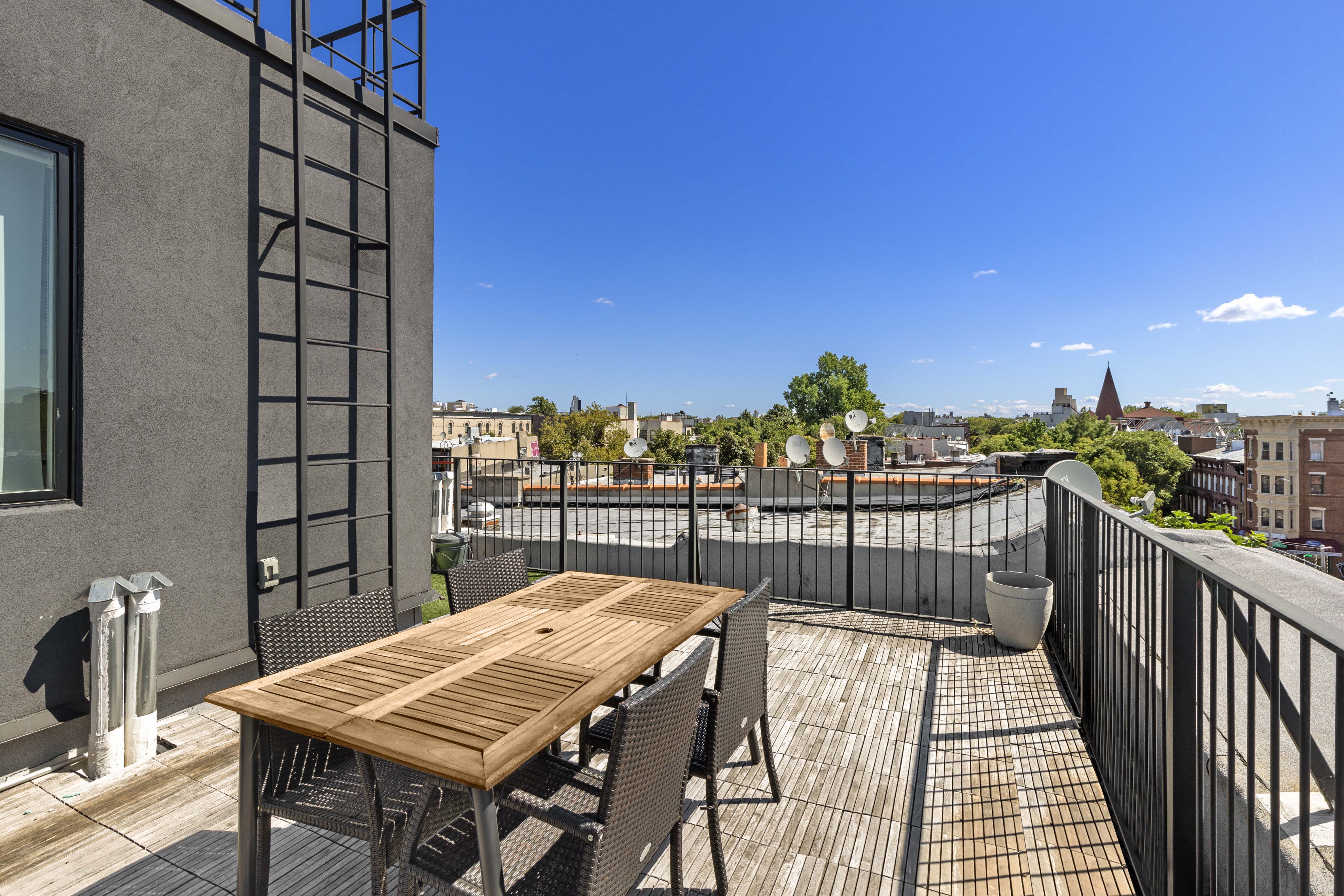 a view of a balcony with an outdoor seating
