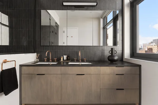 a kitchen with stainless steel appliances granite countertop a sink and a white cabinets