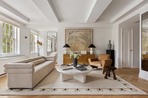 a living room with furniture a table and chair